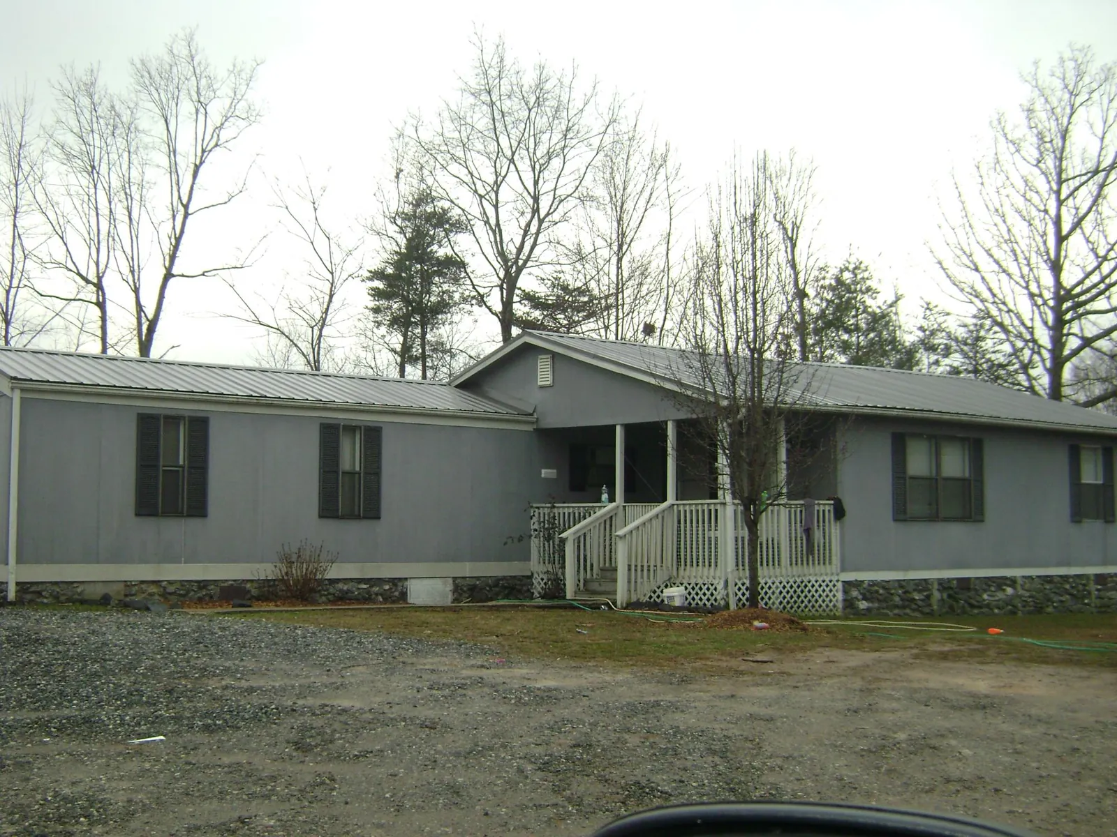 Metal roof over a manufactured home with a covered front porch in Southport
